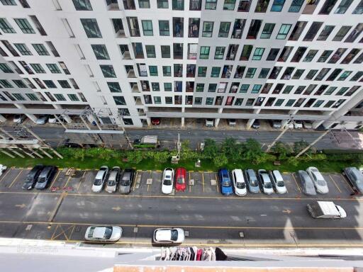 View of a modern residential building and its parking lot