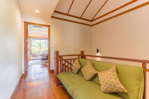 Hallway with Sofa and Wooden Railings