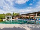 Luxurious outdoor pool area with ample lounge chairs and umbrellas