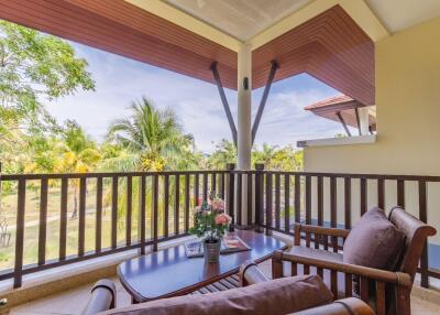 A cozy balcony with outdoor seating and a scenic view