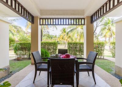 Outdoor porch with dining table and garden view