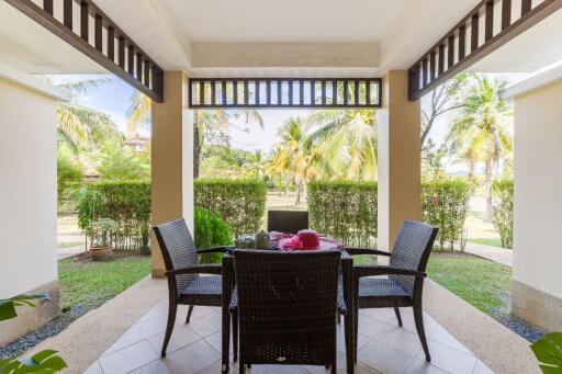 Outdoor porch with dining table and garden view