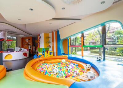 Colorful and spacious playroom with ball pit and large windows