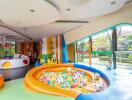 Colorful and spacious playroom with ball pit and large windows