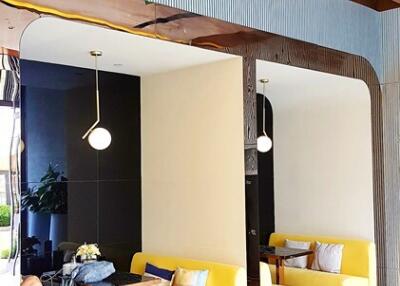 Modern lobby with yellow seating area and decorative lighting