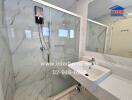 Modern bathroom with a glass shower enclosure, wall-mounted water heater, and sink with a mirror