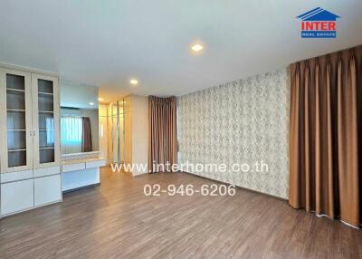 Spacious living room with wooden floor and modern fixtures