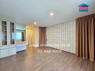 Spacious living room with wooden floor and modern fixtures