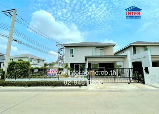 Modern two-story house with a gated yard