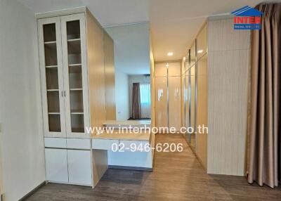 Modern bedroom with built-in wardrobes and vanity area
