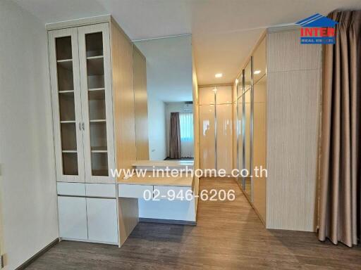 Modern bedroom with built-in wardrobes and vanity area