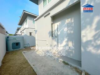 Backyard view with exterior unit and storage door