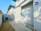 Backyard view with exterior unit and storage door