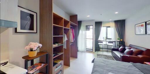 Modern studio apartment with living area, wardrobe, and dining space