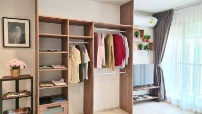 Modern bedroom with open wardrobe and natural light