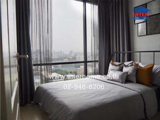 Modern bedroom with large windows and city view