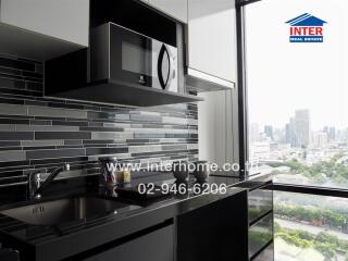 modern kitchen with black and white cabinetry and city view