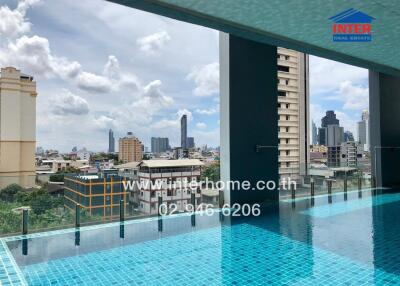 View of the city skyline from a rooftop swimming pool