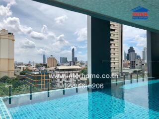 View of the city skyline from a rooftop swimming pool