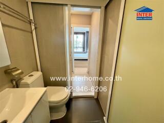 Modern small bathroom with view of a bedroom through sliding doors