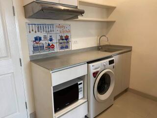 Compact kitchen with washing machine, microwave and countertop