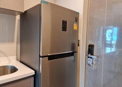 Modern kitchen with stainless steel refrigerator and sink