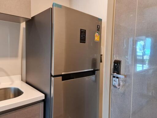 Modern kitchen with stainless steel refrigerator and sink