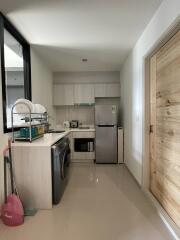 Modern kitchen with light wood cabinets and appliances