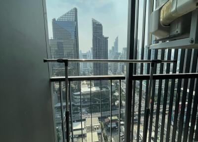 View from a high-rise balcony overlooking city skyscrapers