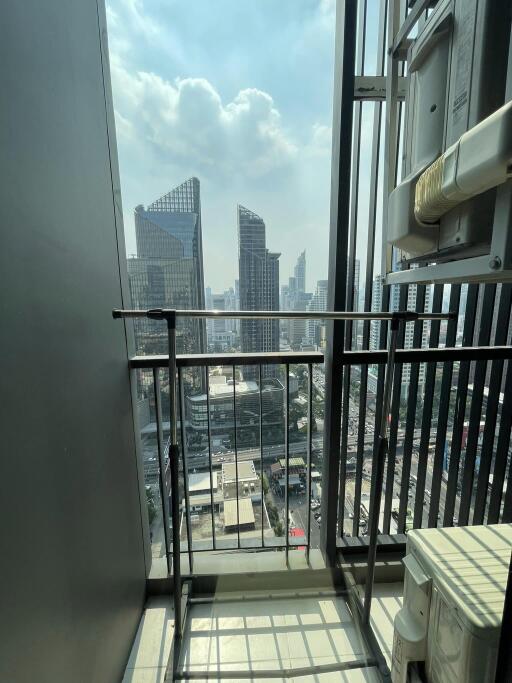 View from a high-rise balcony overlooking city skyscrapers