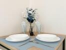Elegant dining area setup with tableware and floral arrangement