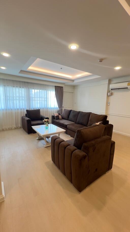 Spacious living room with modern furniture and ample natural light