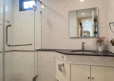 Modern bathroom with glass shower enclosure and vanity