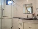 Modern bathroom with glass shower enclosure and vanity