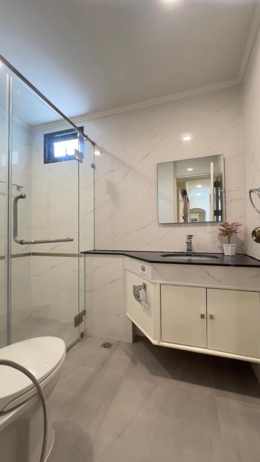 Modern bathroom with glass shower enclosure and vanity