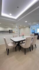 Modern dining area with elegant furniture and an open kitchen