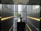Mailroom with reflective black floors, centered flower arrangement, and wall of mailbox slots