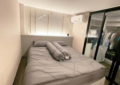Modern and cozy bedroom with a queen-sized bed and closet space