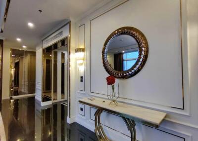Elegant hallway with decorative mirror and marble console table.