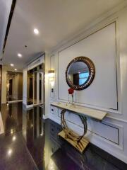 Elegant hallway with decorative mirror and marble console table.