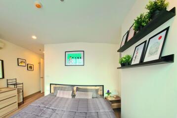 Modern bedroom with artwork and plants