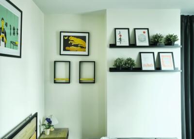 Artistic modern bedroom with framed artwork and plants