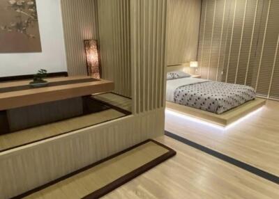 Elegant, modern bedroom with textured wall and built-in wooden furnishings