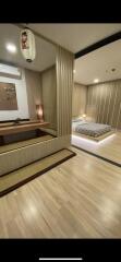 Elegant, modern bedroom with textured wall and built-in wooden furnishings