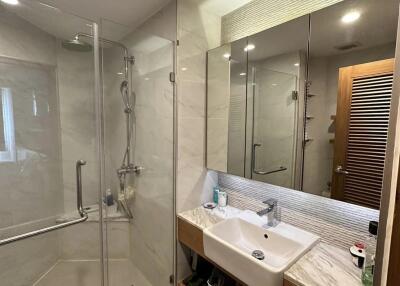 Modern bathroom with glass shower and large mirror