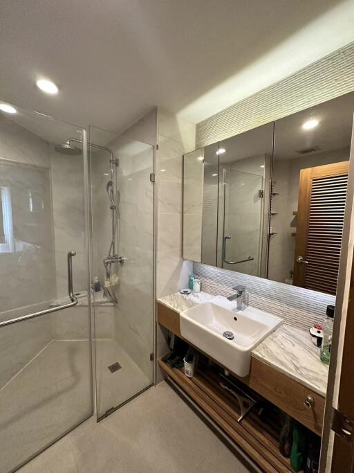 Modern bathroom with glass shower and large mirror