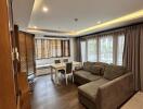 Modern living room with dining area and natural lighting