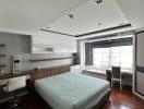 Modern bedroom with double bed, wooden floor, and study area