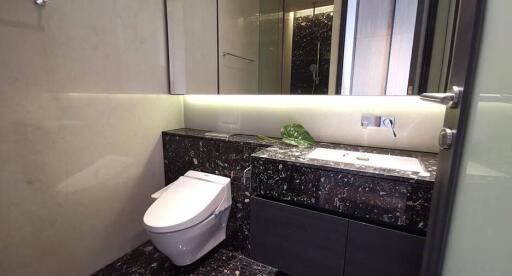 Modern bathroom with marble countertop and toilet