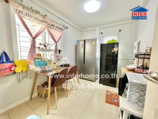 Well-lit kitchen with modern appliances and a dining area